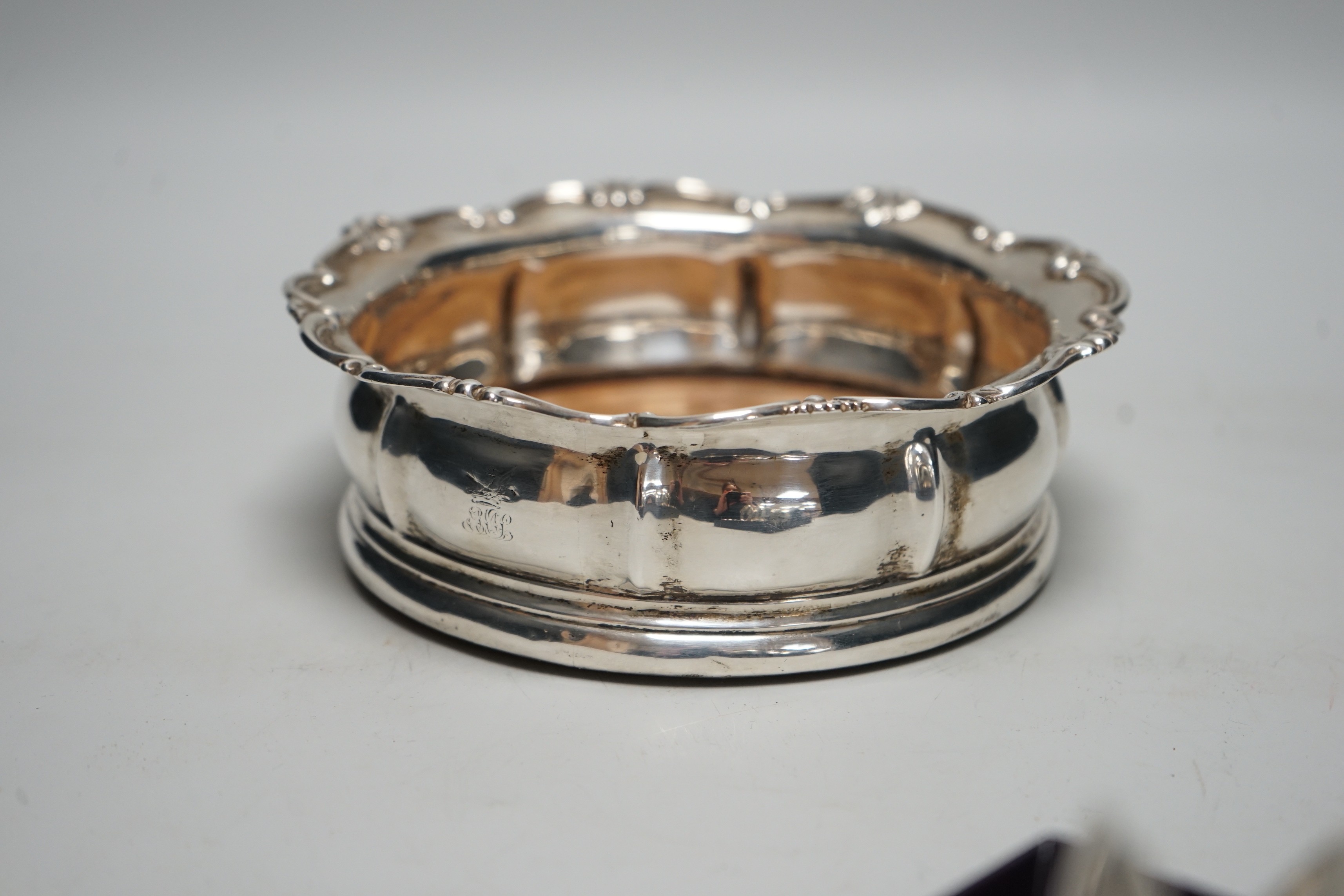 An early Victorian silver mounted wine coaster, with scrolling border, marks very rubbed, possibly London, 1838, diameter 16cm.